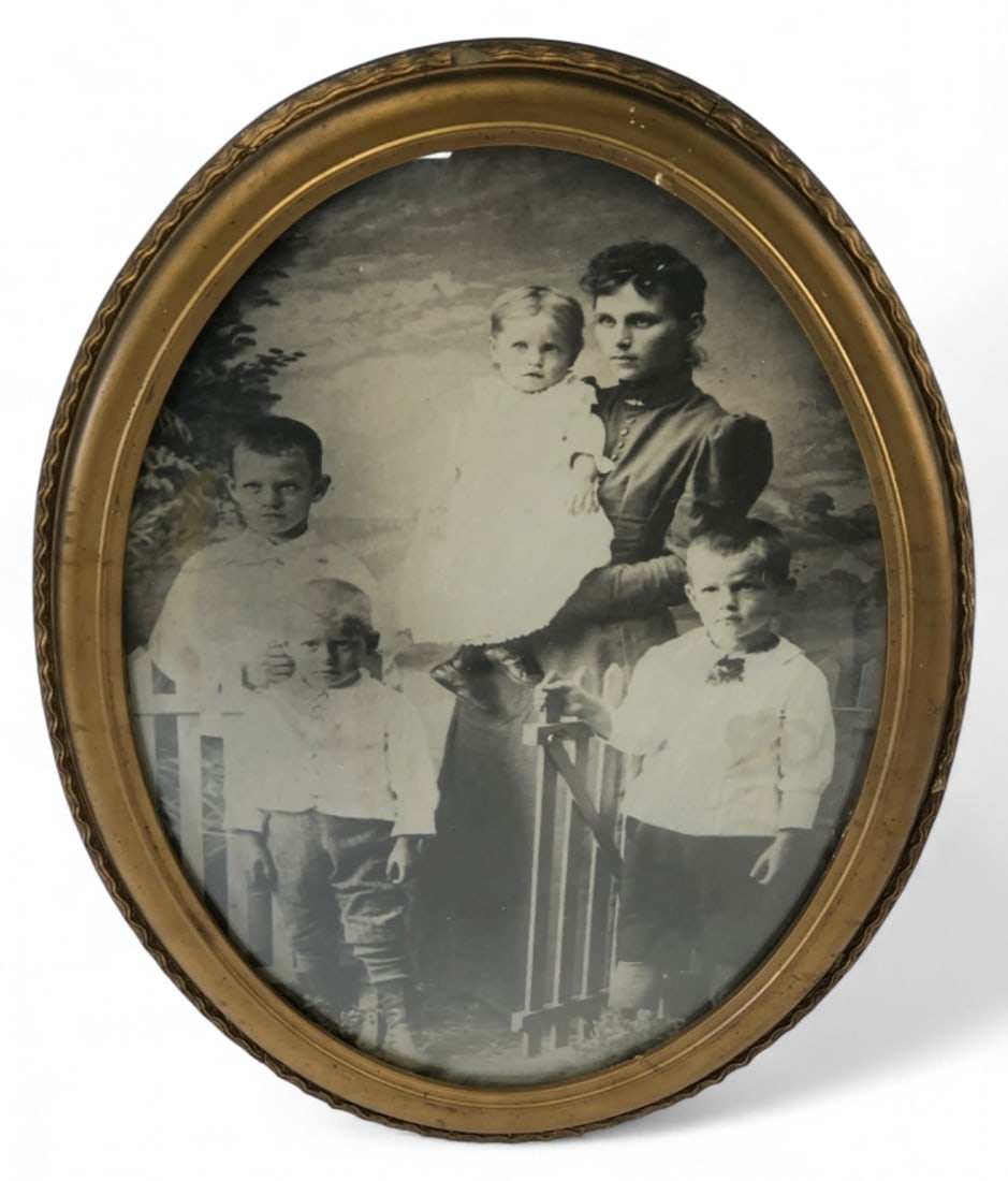 Victorian Bubble Glass Framed Family Photograph: Victorian-era family photograph featuring a woman and four children, housed in an oval bubble glass frame. The frame is gilded wood or composition with a decorative wavy outer edge. A handwritten