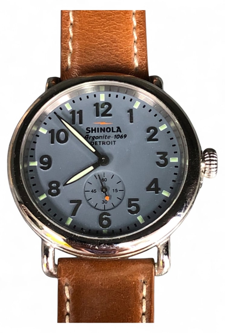 Shinola Argonite-1069 Stainless Steel Wristwatch: Shinola Argonite-1069 wristwatch featuring a blue dial with luminous hands and markers, a sub-second dial, and a stainless steel case. Fitted with a brown leather strap sewn in the USA. Case back mark