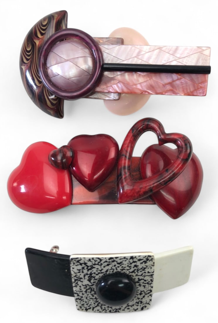 Set of Three French Hair Clips: Set of three decorative hair clips, each marked "Made in France" on the metal hardware. Designs include a geometric mother-of-pearl style, a multi-heart motif, and a black-and-white speckled square ac