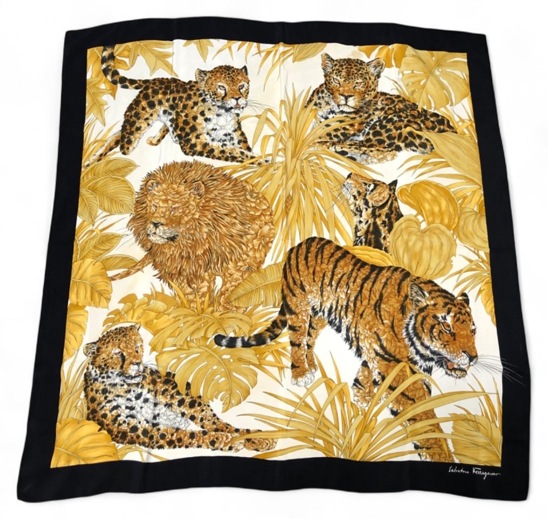 VTG Salvatore Ferragamo Silk Lion & Leopard Scarf: Vintage Salvatore Ferragamo silk scarf featuring a jungle motif with lions, tigers, and leopards amidst golden foliage. Crafted in Italy from 100% silk. Signed 'Salvatore Ferragamo' in the corner. Inc