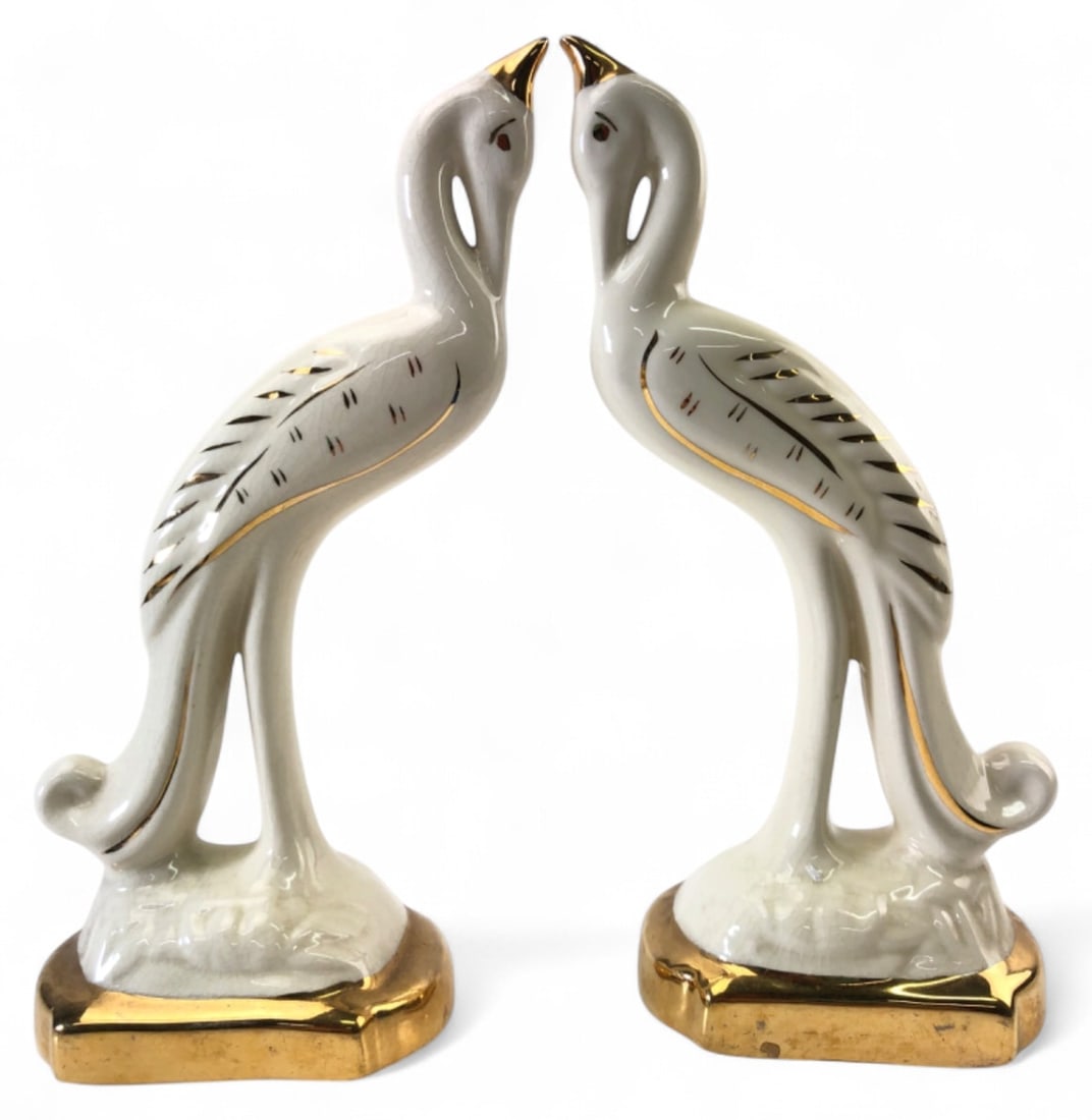Pair of Ceramic Crane Figurines: Pair of ceramic crane figurines featuring white glazed bodies with gold-tone accents on the beaks, wings, and bases. Each measures 10 3/4" H. Figurines are unmarked. Condition appears good with no