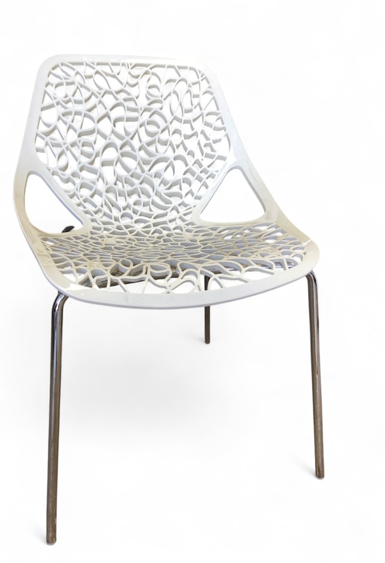 Casprini Caprice White Webbed Chair: Casprini Caprice chair, designed by Marcello Ziliani. Features a white injection-molded nylon seat with an intricate webbed cut-out design and tubular metal legs. Shows scuffs and wear to the top edge