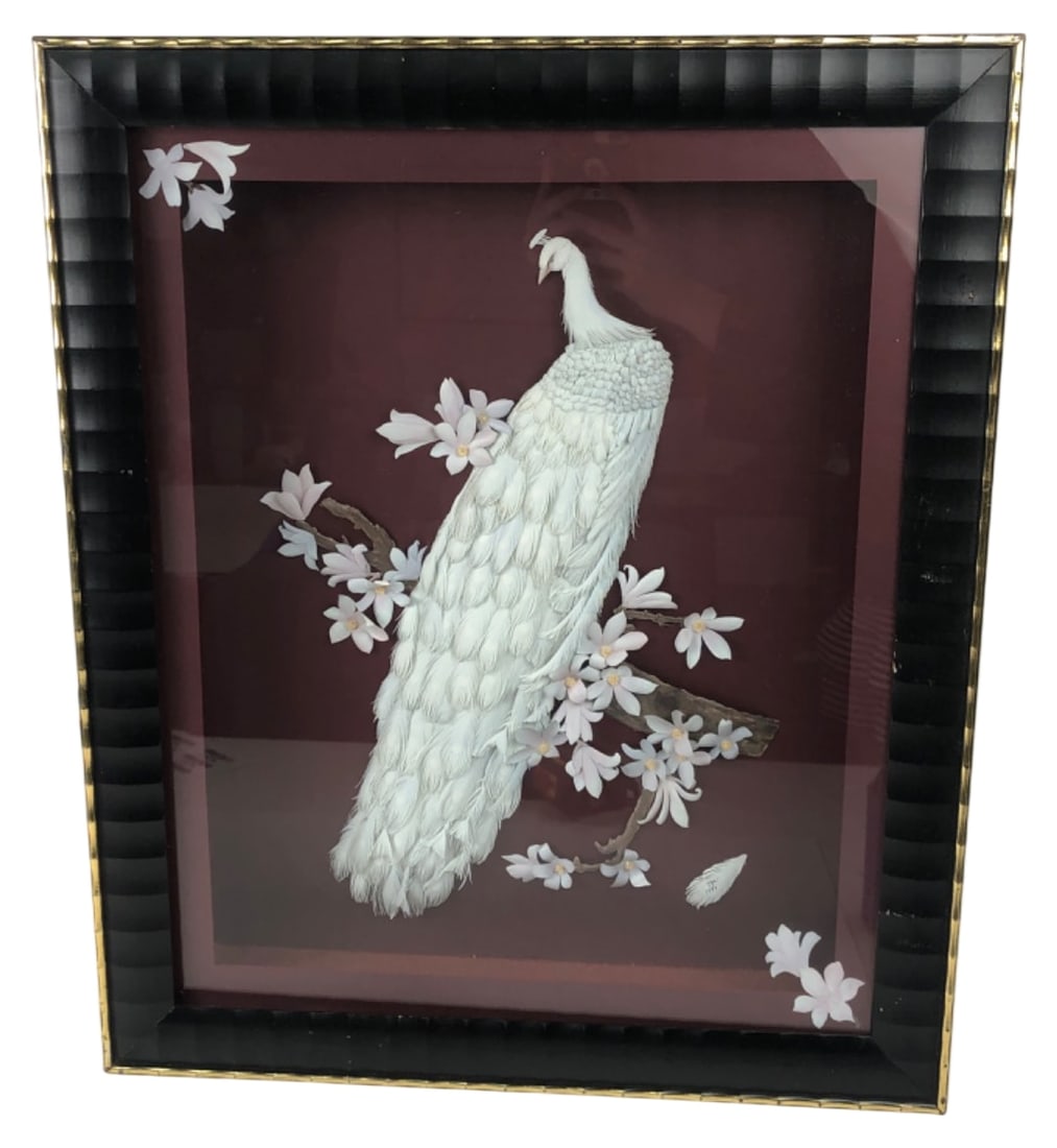 Signed JGE 1999 3D White Peacock Shadowbox Art: 3D relief artwork of a white peacock on a floral branch, housed in a black shadowbox frame with gold trim. The peacock appears to be crafted from layered feathers or cut paper. Signed "jge" and dated