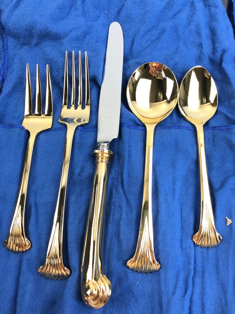 Supreme Cutlery Gold Tone Flatware 12 Plate Settings: Large flatware service by Supreme Cutlery, Japan. Crafted from 18-8 stainless steel with a gold-tone finish. Features an elegant shell motif on the handle terminals. Includes forks, knives, and spoons