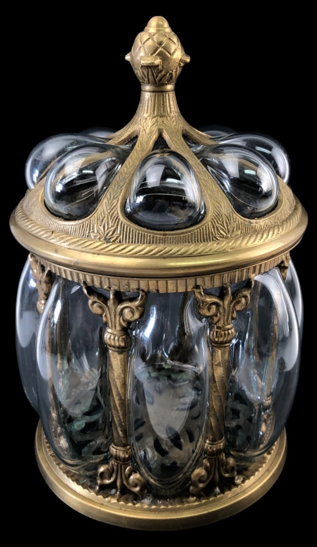 VTG Baroque Brass Bubble Glass Apothecary Jar: Vintage baroque-style brass and clear bubble glass apothecary jar with lid. Features ornate brass pillars and an acorn finial. Unmarked. Measures 13" H with lid on. Condition: shows wear, tarnishing