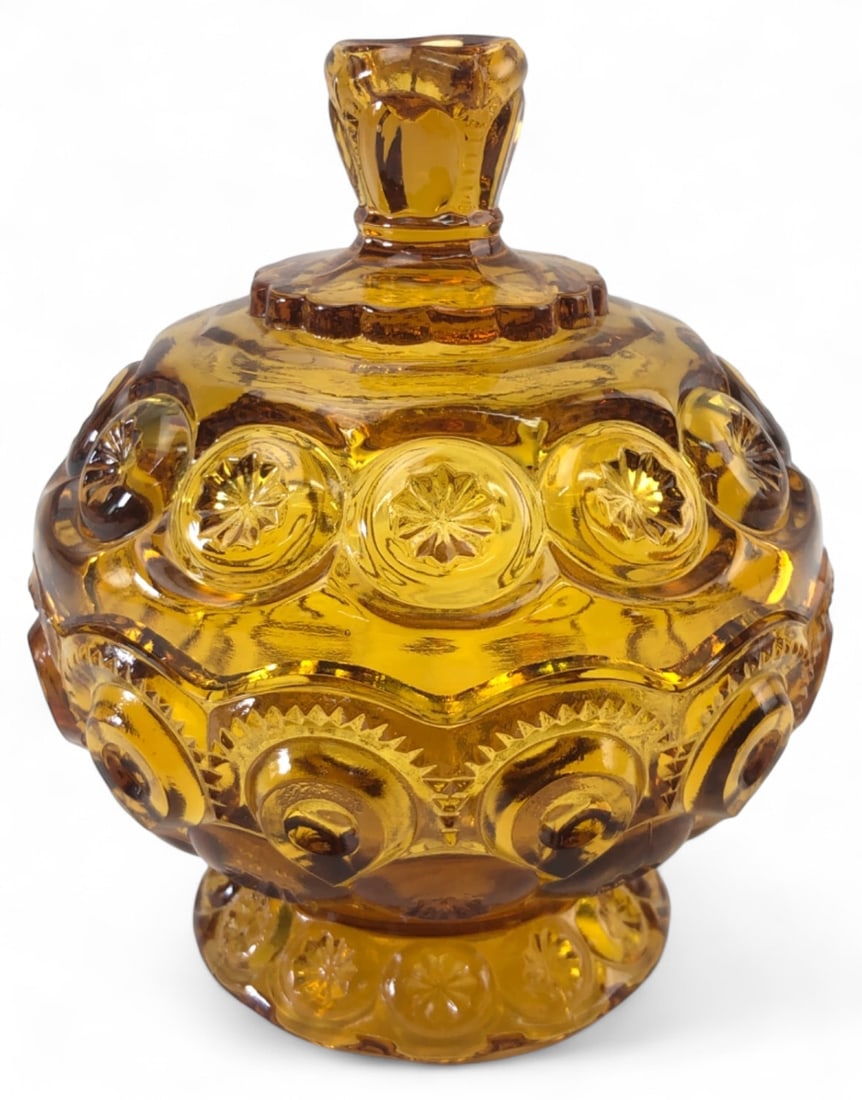 VTG LE Smith Moon and Stars Amber Lidded Dish: Vintage L.E. Smith lidded dish in the iconic Moon and Stars pattern. Crafted from amber pressed glass featuring a scalloped footed base and matching lid with finial. Measures 5.5" H. Shows typical min