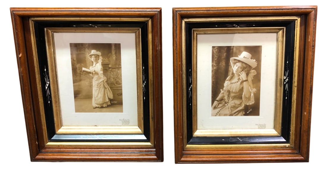 Pair Otto Sarony Co. Framed Photographs: Pair of framed sepia portrait photographs by Otto Sarony Co., New York. Features women in Edwardian dress holding books. Housed in wood frames with black and gold accents. Signed in negative and stamp