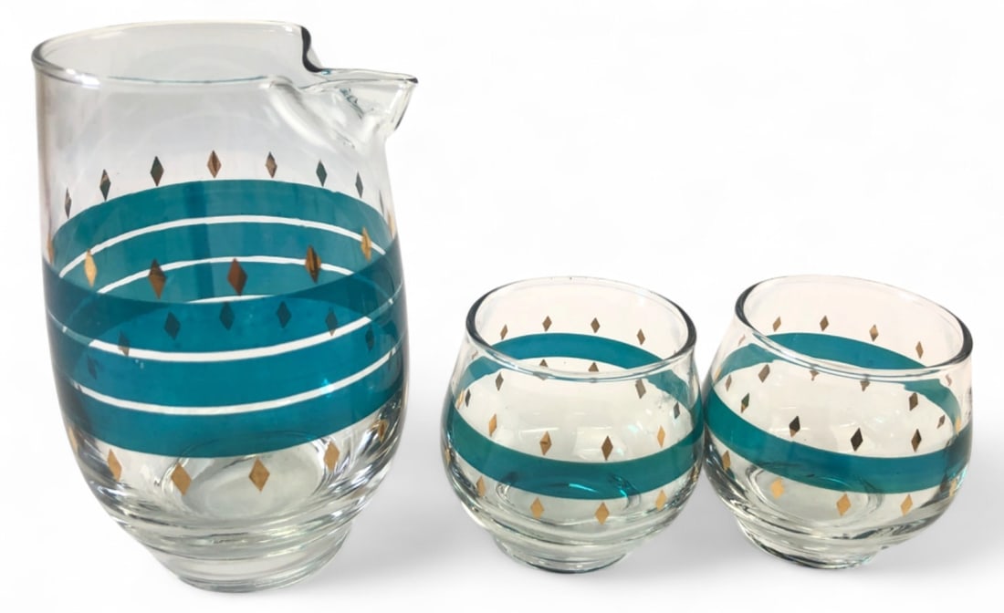 VTG Libbey San Juan Glass Barware Set: 3-piece vintage Libbey glass barware set in the San Juan pattern. Includes a pitcher measuring 5.25" H and two glasses measuring 2" H. Features clear glass decorated with teal horizontal bands and gol