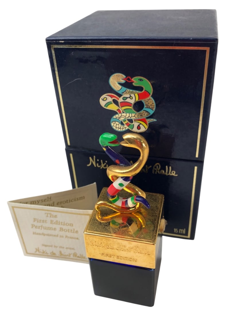Niki de Saint Phalle First Edition Perfume Bottle: Niki de Saint Phalle First Edition parfum bottle. Features a cobalt blue glass base with a gold-tone intertwined snake stopper, hand-painted with colorful enamel. Includes original presentation box an