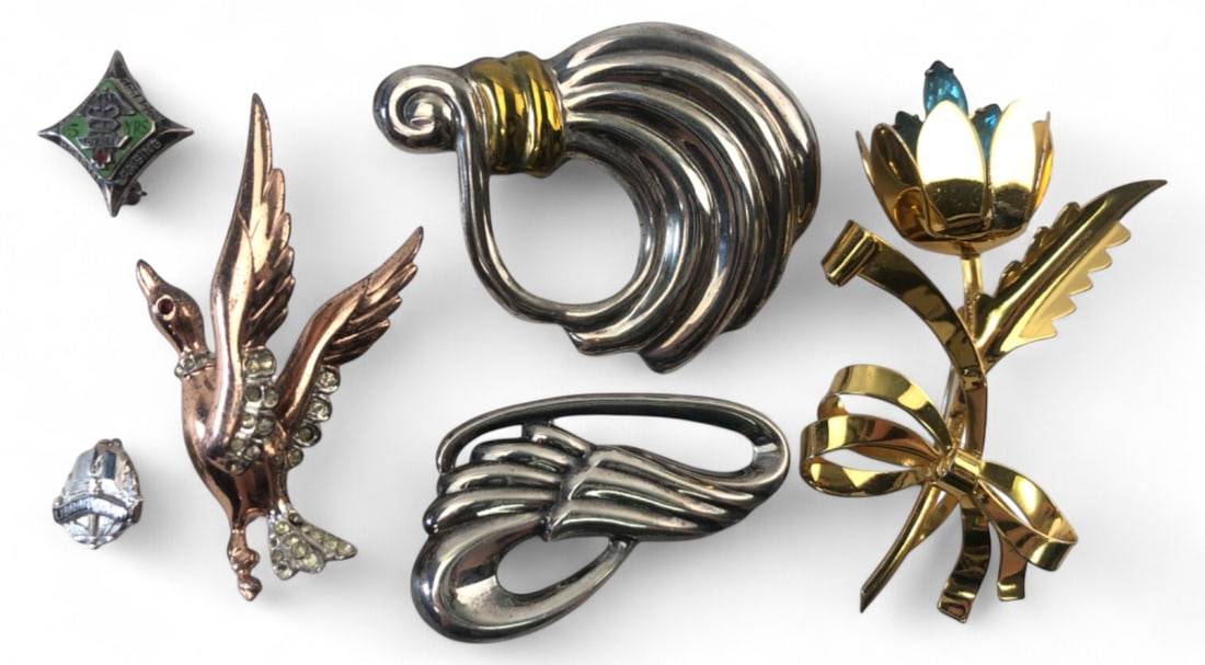 Assorted Sterling Silver Brooch Pin Lot: Lot of six brooches and pins. Includes a gold-washed sterling flower brooch with blue rhinestones marked STERLING, a Mexican sterling swirl brooch marked MEXICO 925, a Thai sterling abstract wing