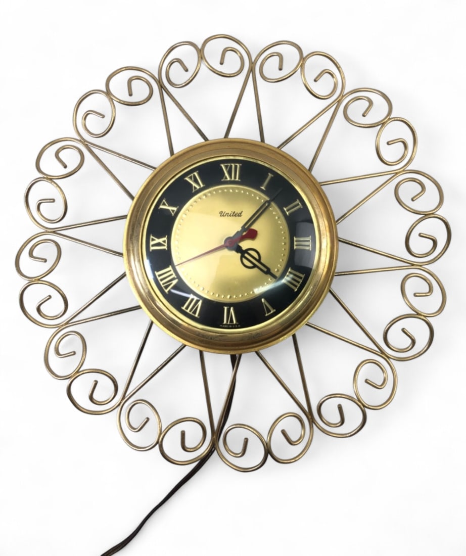 MCM United Sunburst Electric Wall Clock: Mid-Century Modern sunburst electric wall clock by United Clock Corp., Brooklyn, N.Y., Model No. 87. Features a gold-tone wire frame, black and gold dial with Roman numerals, and domed glass. Tested