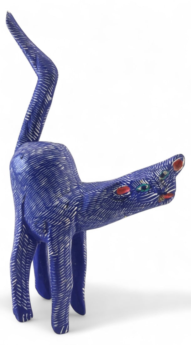 Martin Fabian Xuana Carved Wood Cat Alebrije: Carved and painted wooden cat alebrije by Mexican folk artist Martin Fabian Xuana. Features a blue base with white dash patterns and painted facial details. Signed "Martin Fabian Xuana" on the