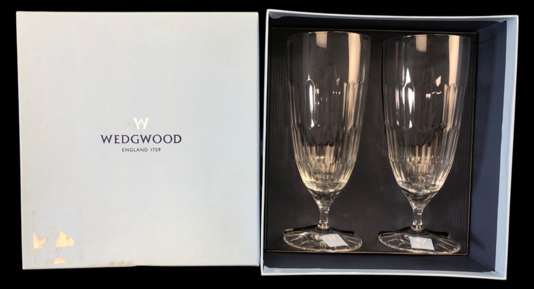 Wedgwood Thirlmere Crystal Iced Tea Glasses Pair: Pair of Wedgwood crystal iced tea glasses in the Thirlmere pattern. Made in Germany. Features vertical cuts on the lower bowl and a cut foot. Both retain original stickers and bear etched Wedgwood