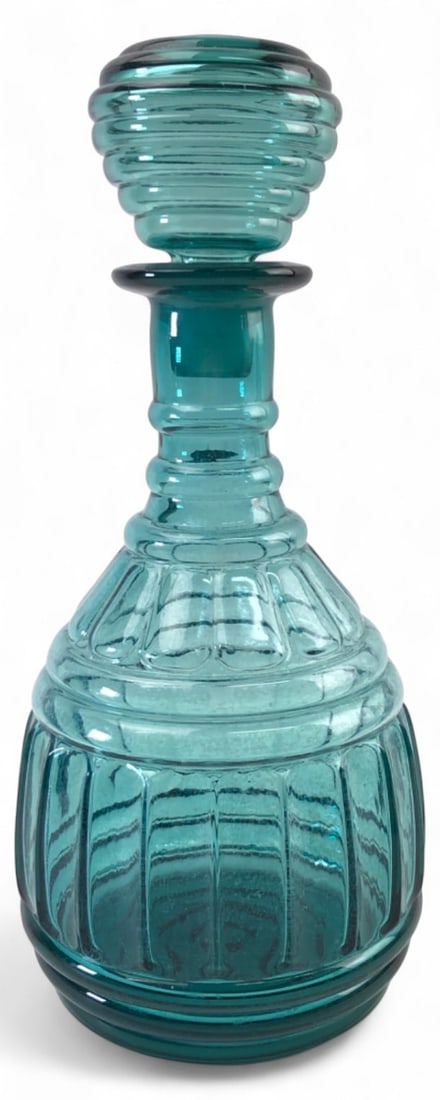 MCM Imperial Glass Aquamarine Genie Decanter 11"H: Mid-Century Modern aquamarine glass genie decanter with matching stopper by Imperial Glass. Features a ribbed, bulbous body with a tiered neck and stopper. Unmarked. Good condition with a few chips
