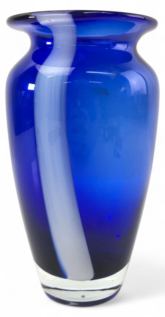 Cobalt Blue & White Art Glass Vase 7.5" H: Hand-blown art glass vase featuring a deep cobalt blue body accented with a thick white vertical swirl. Designed with a flared rim and a solid clear glass base showing a polished pontil mark. Unmarked