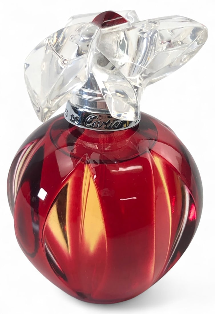 Cartier Paris Delices de Cartier Eau de Toilette 50ml: Cartier "Delices de Cartier" Eau de Toilette perfume bottle. Features a ribbed red glass body with a clear floral-motif stopper accented by a red center stone. Silver-tone spray nozzle. Marked "Delice