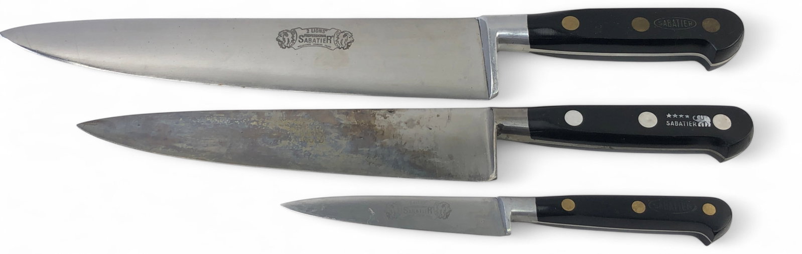 Sabatier 2 Lions & 4 Star Elephant Knife Lot: Lot of 3 French kitchen knives featuring 4", 8", and 10" blades. Includes a 10" 2 Lions Professional Sabatier molybdenum stainless chef's knife with original sleeve, an 8" 4 Star Elephant Sabatier kni