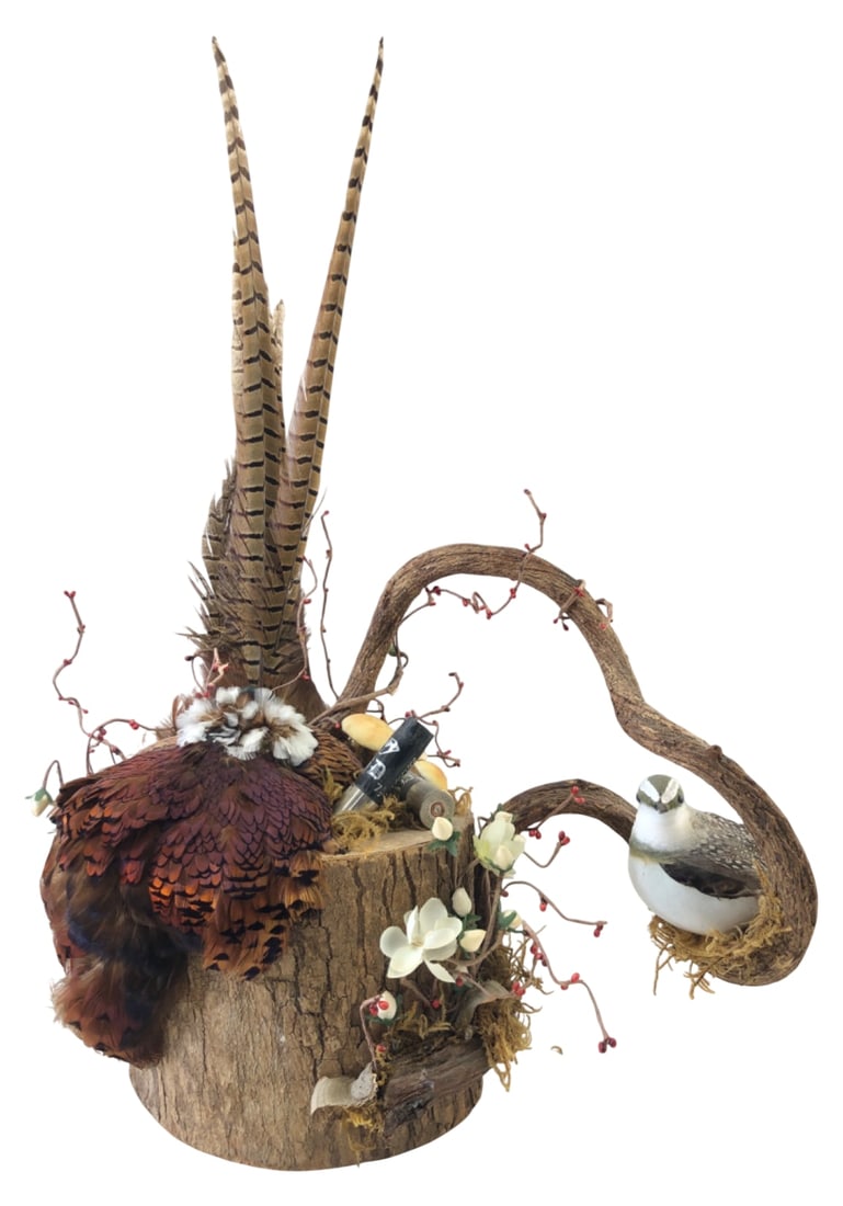 Handmade Rustic Game Bird & Feather Display: Handmade rustic decorative display featuring a wood log base adorned with genuine pheasant feathers, a faux game bird perched on a twisted branch, artificial white flowers, red berries, moss, and two