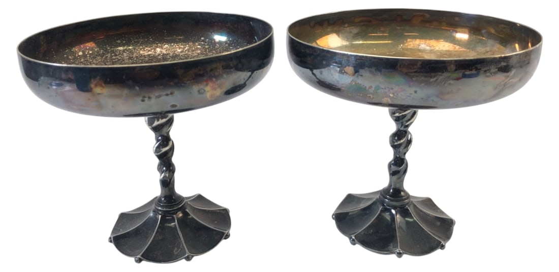 Reed & Barton 1031 Silver Plated Compotes: Pair of silver plated compotes by Reed & Barton, model 1031. Features a shallow bowl on a twisted stem with a scalloped base. Stamped "Reed & Barton 1031" on the underside. Both show heavy tarnish,