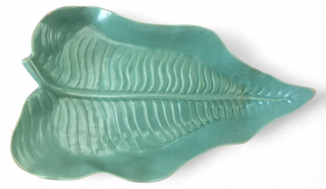 Rare Catalina Pottery Mint Green Leaf Dish: Rare 1940s Catalina Pottery mint green leaf-shaped dish. Features a detailed veined design and glossy glaze. Marked "Catalina Made in U.S.A. Pottery" on the base. Measures 14.25" long. Condition: show