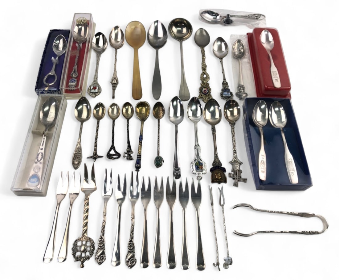 Collection of Souvenir Spoons & Forks: Large collection of souvenir and collector spoons, forks, and sugar tongs. Includes pieces from Venezia, Las Vegas, Stratford, Versailles, and Ireland. Features a Rolex Bucherer spoon, enamel crests, 