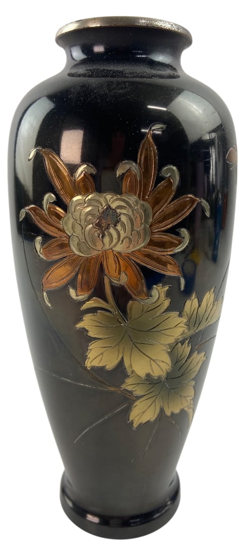 Japanese Mixed Metal Chrysanthemum Vase: Japanese dark patinated metal vase featuring mixed metal floral inlay of a chrysanthemum in gold, silver, and copper tones. Silver-toned rim. Base marked Japan with retailer sticker for Margaret's, Ka