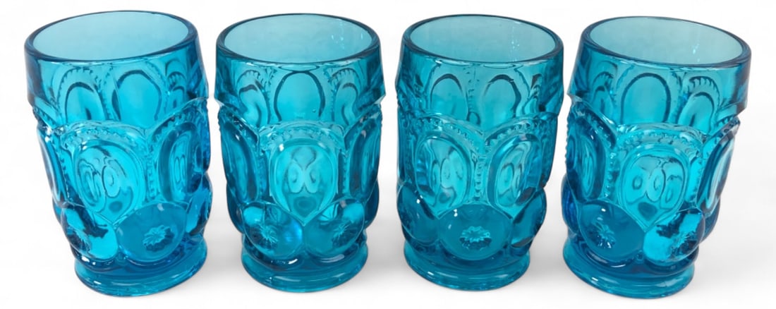 VTG L.E. Smith Moon & Stars Blue Tumblers: Set of four vintage L.E. Smith pressed glass tumblers in the Moon and Stars pattern. Features a vibrant blue color with the classic raised star and circle motif. Each glass measures 5" H. Unmarked, at