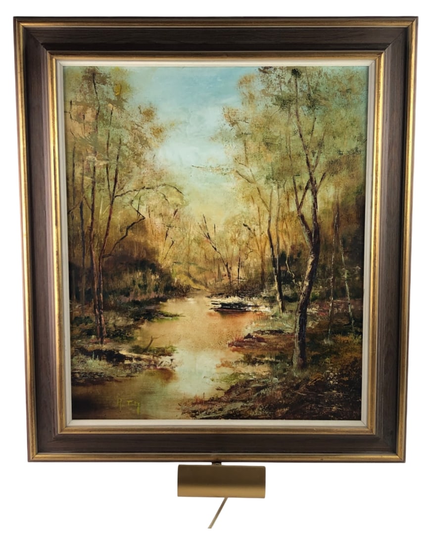 Signed R. Tiy Framed Landscape Oil Painting: Framed landscape oil painting depicting a serene river scene, signed "R. Tiy" in the lower left. Housed in a wood frame with a gold-tone inner lip. Features an attached vintage brass-tone picture ligh