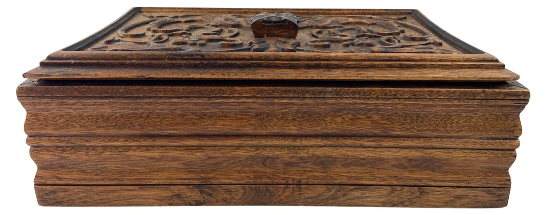 Antique Walnut Renaissance Revival Jewelry Box: Antique hand-carved walnut jewelry or keepsake box in the Renaissance Revival style. Features an intricately carved foliate scrollwork lid with a central knob and stepped molding on the sides.