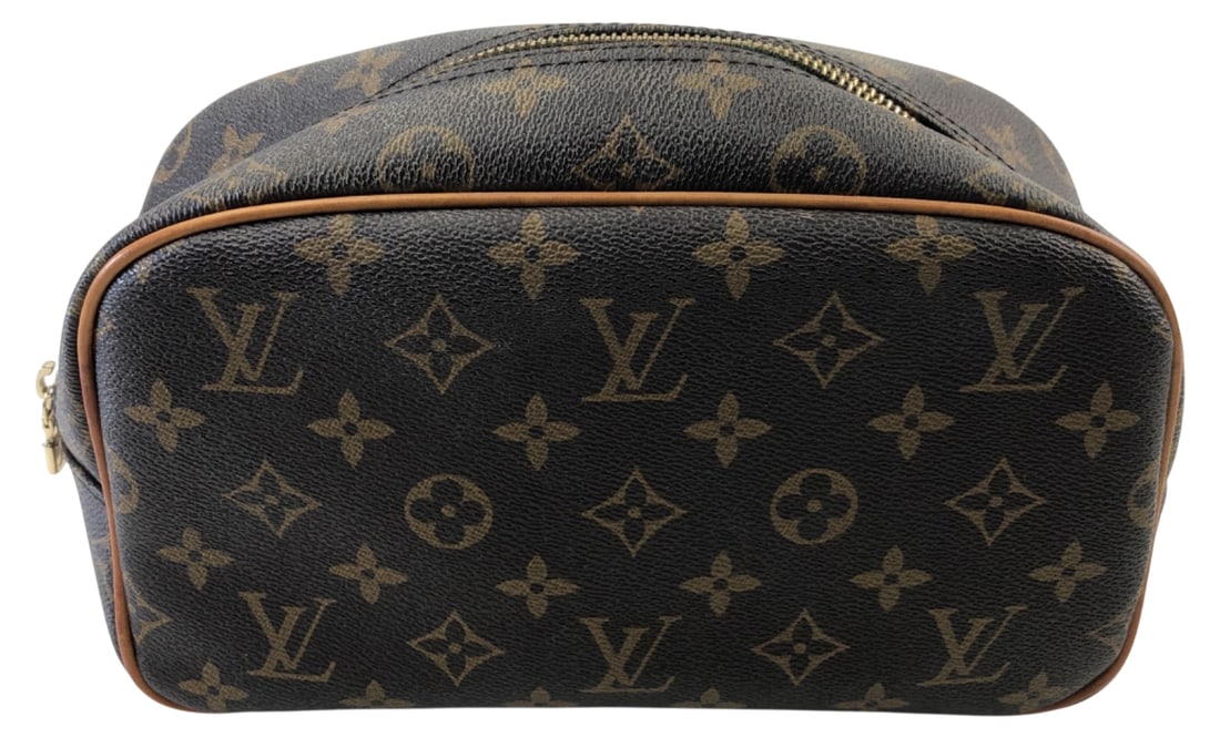 Louis Vuitton Monogram Cosmetics Bag: Monogram coated canvas cosmetics bag bearing marks for Louis Vuitton. Features leather piping, zip closure with LV pull, and brown interior lining. Interior leather tag stamped "LOUIS VUITTON PARIS ma