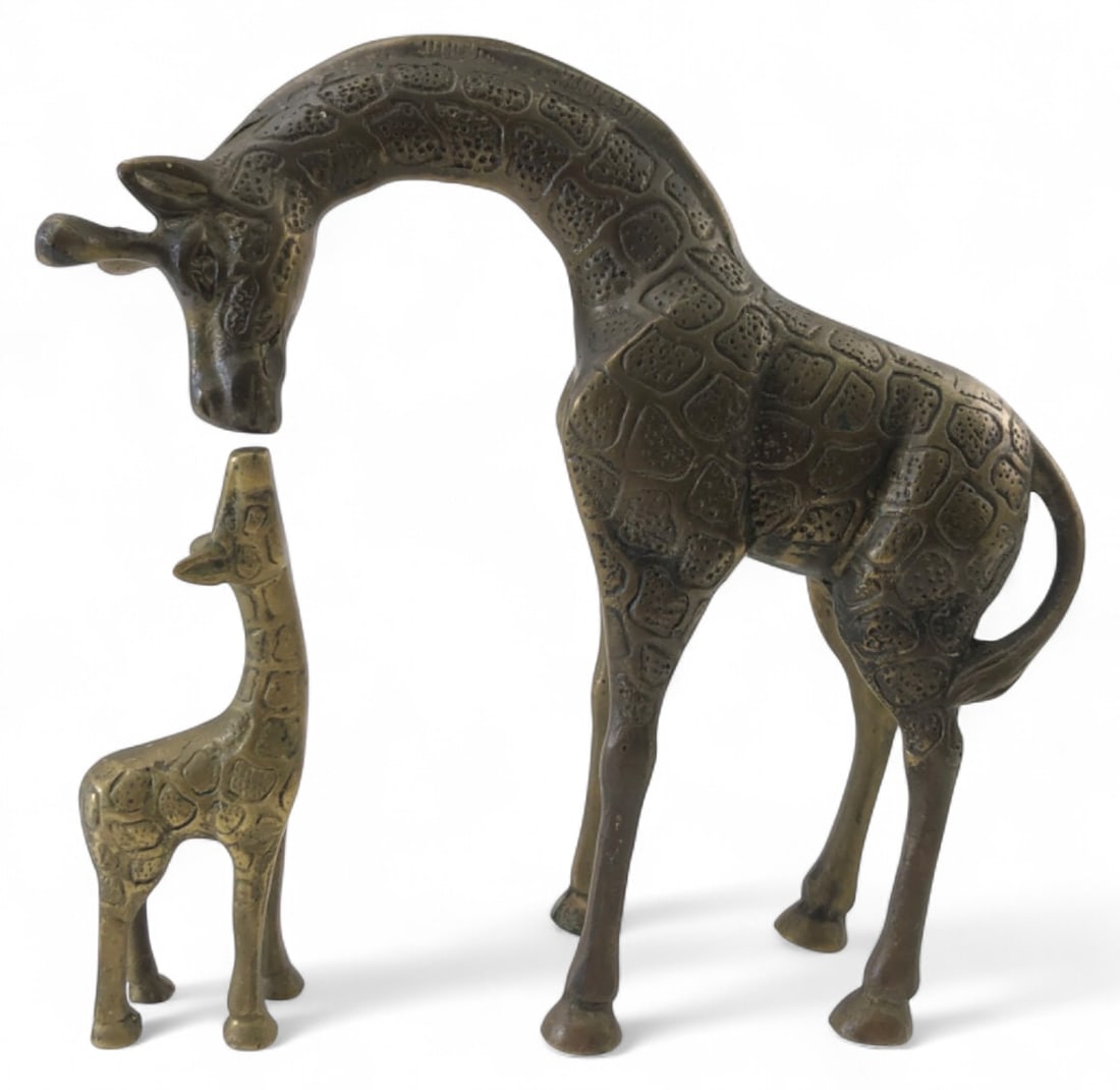 Pair of Brass Giraffe Figures: Pair of brass giraffe figures, including one adult and one calf. Unmarked. Features textured spot patterns throughout. Measures 5"H and 8.5"H. Shows typical wear, tarnish, and scattered verdigris