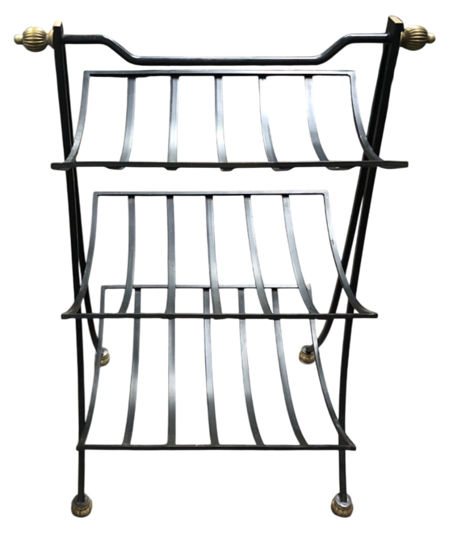 MCM Black Metal & Brass Tone Magazine Rack: Black painted metal magazine rack featuring a curved slatted design and a central top handle. Accented with ribbed brass-tone finials and matching feet with felt pads. Unmarked. Shows minor wear to