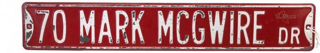 MLBPA Mark McGwire Signed 70 Home Run Sign: Red metal street sign reading '70 MARK MCGWIRE DR', signed in gold marker by Mark McGwire and dated 9-27-98, commemorating his 70th home run. Features embossed white lettering and an MLBPA Players