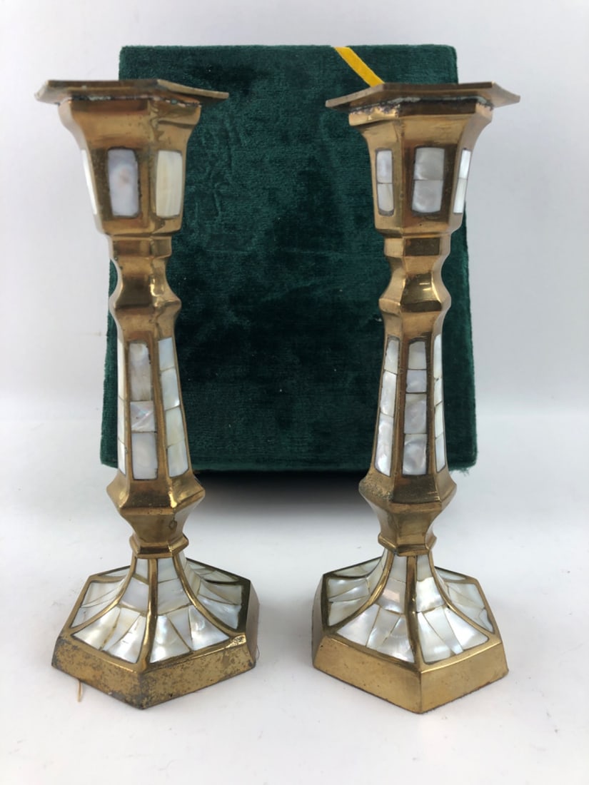 Pair Brass & Mother of Pearl Candlesticks 8"H: Pair of unmarked brass candlesticks featuring hexagonal bases and stems inlaid with mother of pearl panels. Measures 8" H. Shows tarnish, surface wear, and wax residue in the cups consistent with age