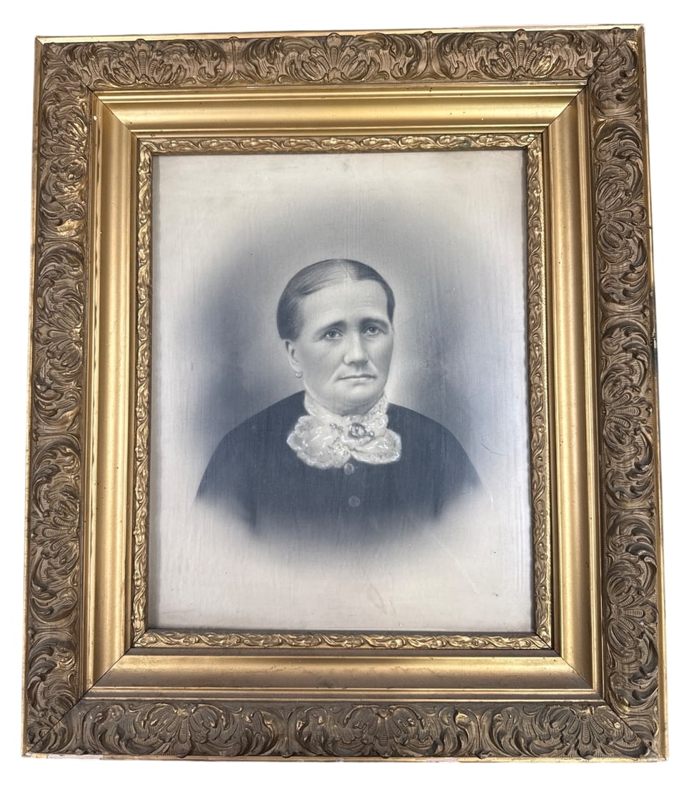 Antique Framed Portrait: Antique framed portrait, likely a charcoal or crayon enlargement over a photograph, depicting an older woman. Housed in an ornate gold-painted gesso and wood frame measuring 29x25". Handwritten note