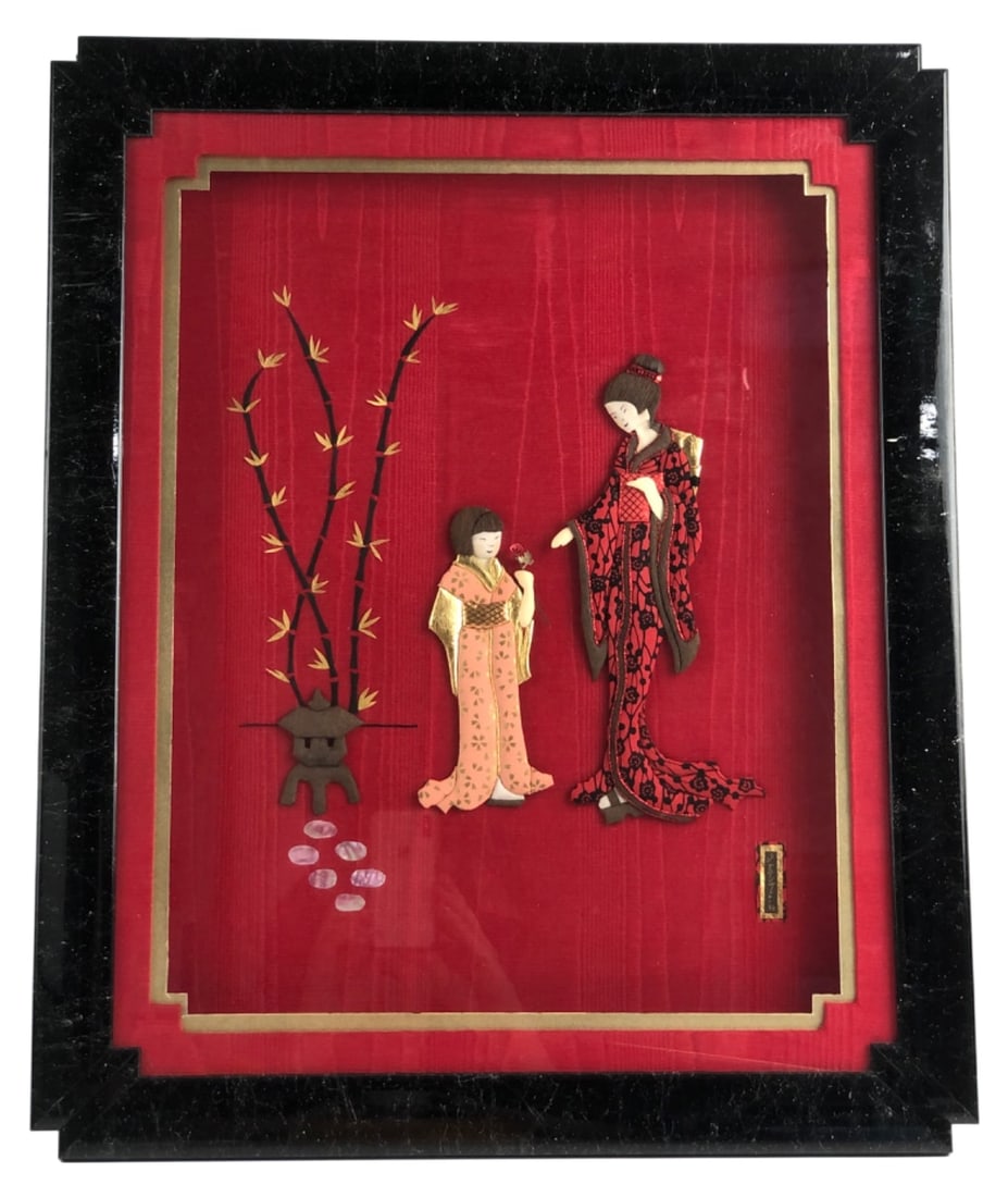 Joan Sato Japanese Oshi-e Fabric Art 19x23": Framed Japanese Oshi-e padded fabric artwork by Joan Sato, dated 1993. Features two figures in traditional kimonos, bamboo, and a lantern against a red fabric background. Signed "Joan Sato 93" in