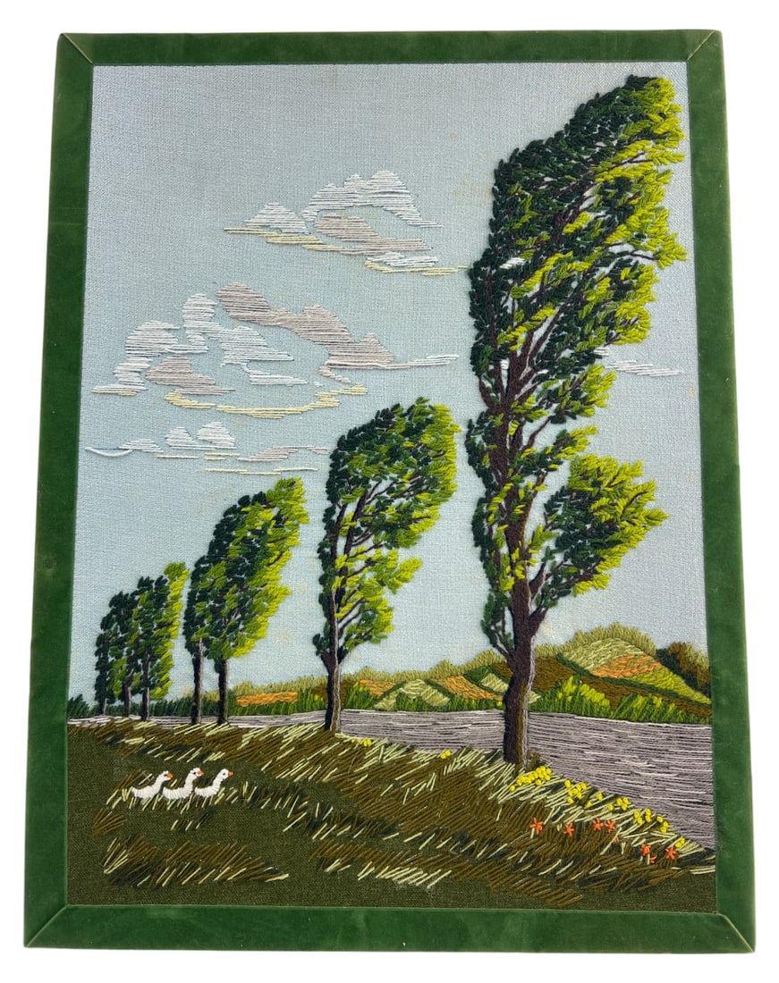 Framed Crewel Embroidery Landscape 24x18: Framed crewel embroidery landscape depicting windswept trees, rolling hills, and three geese. Executed in wool yarn on woven fabric with a green velvet border. Unsigned. Measures 24x18 inches. Shows