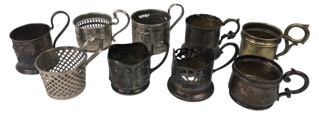 8 Polish Silverplate Tea Glass Holders: Group of 8 Polish silverplate and brass tea glass holders (podstakanniki). Marked by prominent Warsaw makers including Norblin & Co, Fraget, and Henneberg. Features pierced, repoussé, and classical m
