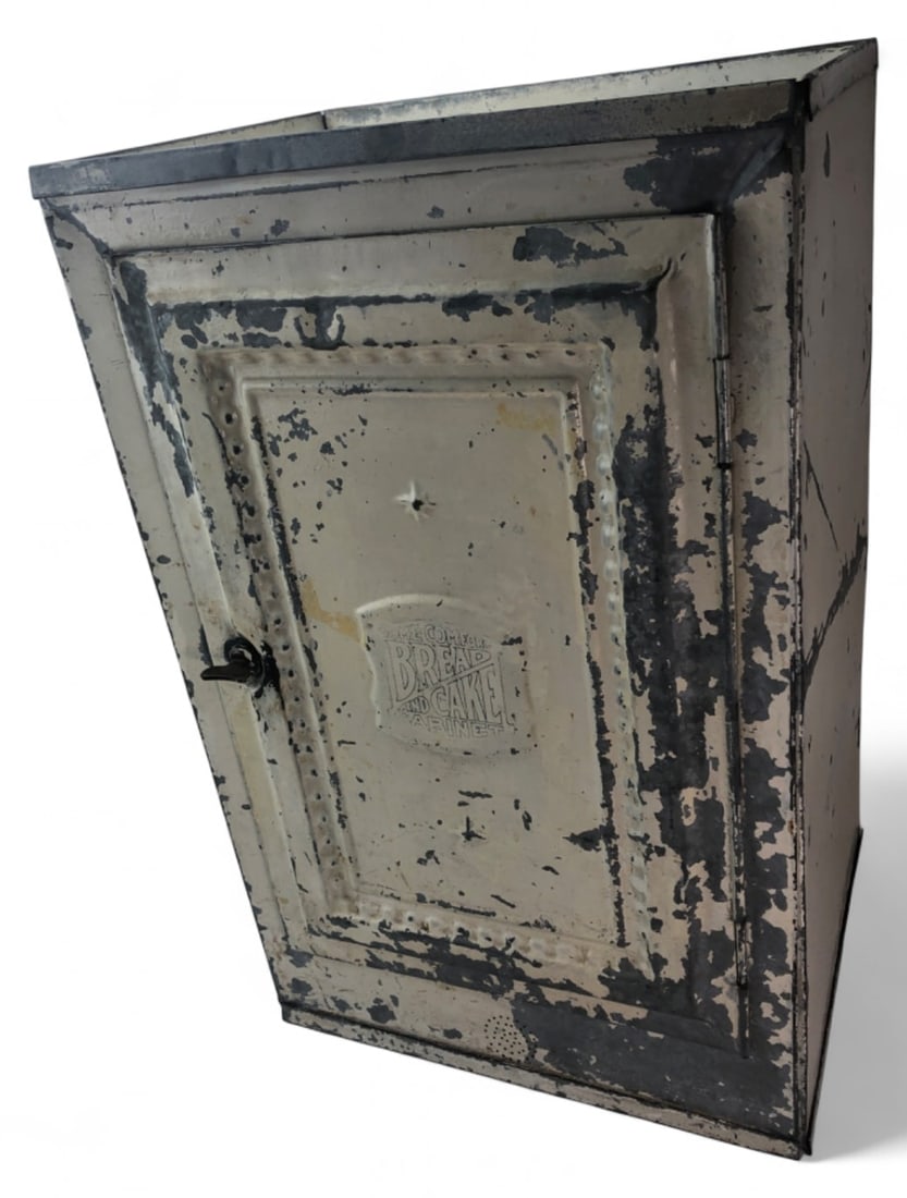 Home Comfort Tin Bread and Cake Cabinet: Antique Home Comfort tin bread and cake cabinet, c. 1920s-1930s. Features an embossed door label reading "HOME COMFORT BREAD AND CAKE CABINET", a single interior shelf, and a latch handle. Constructed
