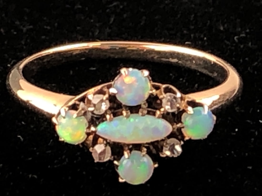 10K Yellow Gold Opal and Diamond Ring: Ladies antique-style ring featuring a central marquise-shaped opal cabochon surrounded by four round opal cabochons and four small round-cut diamonds. Crafted in 10K yellow gold with a decorative