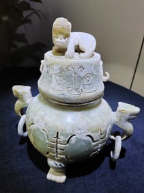 A jade incense burner with a three-legged dragon and a carved "Shou" character on the lid