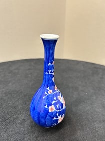 A long-necked vase with blue and white icy plum