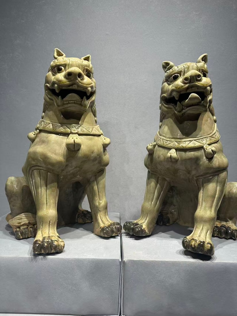 Tang 9th C Yue Celadon Lion Figures (Pair): Tang 9th C Yue Kiln Celadon Lion Tomb Guardians (Pair), Hunan Region.The pair is modeled as powerful lion-form tomb guardians, dating to the 9th century Tang dynasty, with vivid and expressive feature