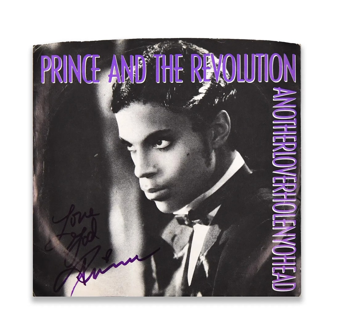 PRINCE - Signed "Anotherloverholenyohead" 7-Inch Single (Prince and the Revolution, 1986): PRINCE - SIGNED "ANOTHERLOVERHOLENYOHEAD" 7-INCH SINGLE (PRINCE AND THE REVOLUTION, 1986) Provenance and Authenticity: The sleeve is signed in bold marker by Prince, positioned across the lower left