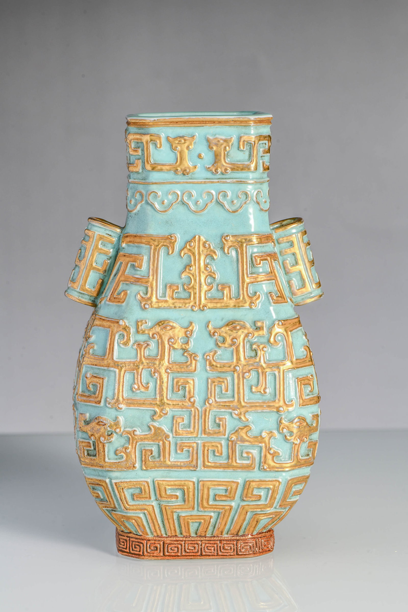 A turquoise-glazed carved with gilt-decorated 'dragon' vase: A TURQUOISE-GLAZED CARVED WITH GILT-DECORATED 'DRAGON' VASE Description: Width:9.5cm, Height:17cm