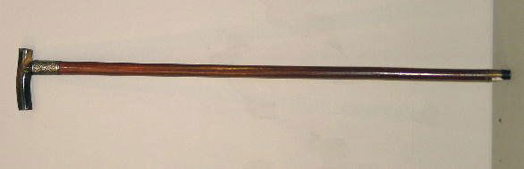 GADGET CANE. Wooden shaft with a horn handle and re: GADGET CANE. Wooden shaft with a horn handle and repousse English silver ferule with Birmingham hallmarks for 1898. Monogrammed and dated "1899". Inside the handle is a syringe marked "DRGM" with vari