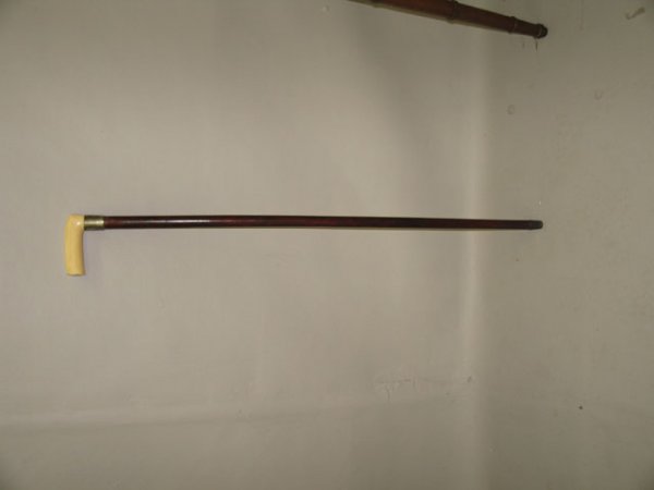 GADGET CANE. Wooden shaft and an ivory handle. The: GADGET CANE. Wooden shaft and an ivory handle. The silver plate ferule is engraved "James Lowe, Wigan Lancs." Inside the handle are three surgical tools marked with a fish and engraved "R.S. I. of O."