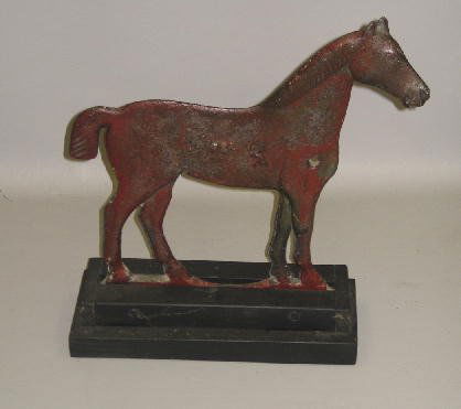 WINDMILL WEIGHT. Cast iron bobtailed horse by the: WINDMILL WEIGHT. Cast iron bobtailed horse by the Dempster Mill Manufacturing Company, Beatrice, Nebraska. Faint cast numbers on the side. Worn red repaint. 17 3/4"l. 18 1/8"h. including modern wooden