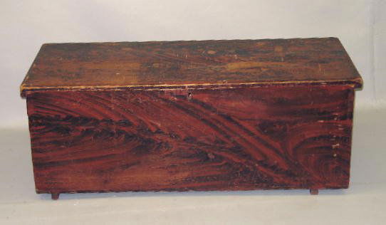 DECORATED BLANKET CHEST. Poplar and ash. Black ove: DECORATED BLANKET CHEST. Poplar and ash. Black over red graining. Dovetailed, battened lid and batten feet (one replaced). Pieced repair and some paint loss to lid and touch ups. 47"w. 19"d. 18"h.