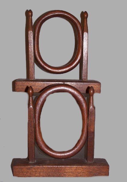 PAIR OF SMALL OVAL FRAMES. Found in Kentucky. Waln: PAIR OF SMALL OVAL FRAMES. Found in Kentucky. Walnut with an old finish. Rectangular chamfered bases with tapered uprights and small egg shaped finials. One oval fits a 3 5/8" x 5" picture, the other